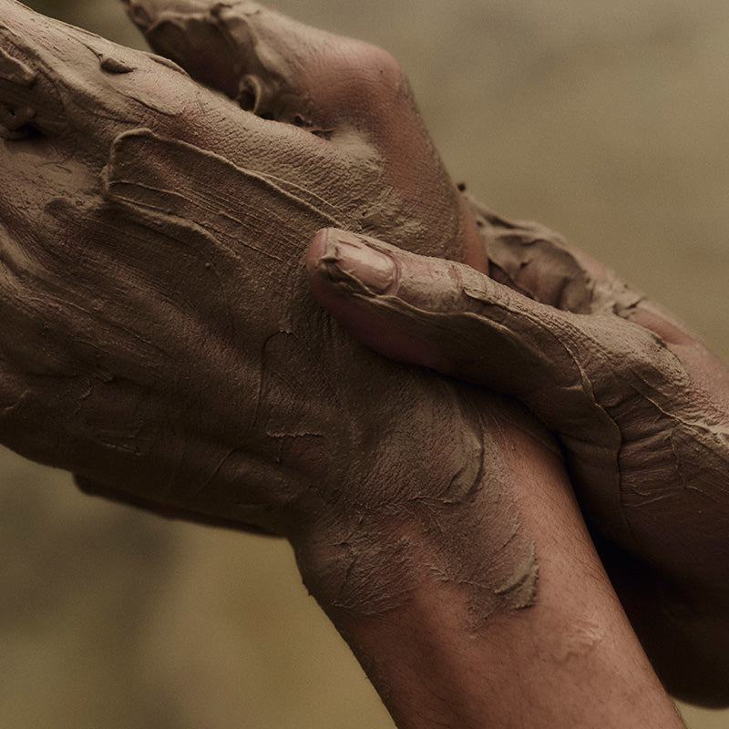 Rubbing mud on hands