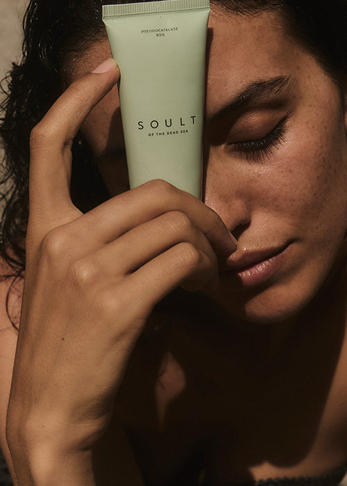 Woman holding SOULT product in front of her face